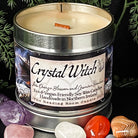 Candle in a metal container labeled 'Crystal Witch' surrounded by crystals and leaves.