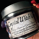 Jar of 'Crystal Witch' candle with a label on a dark background